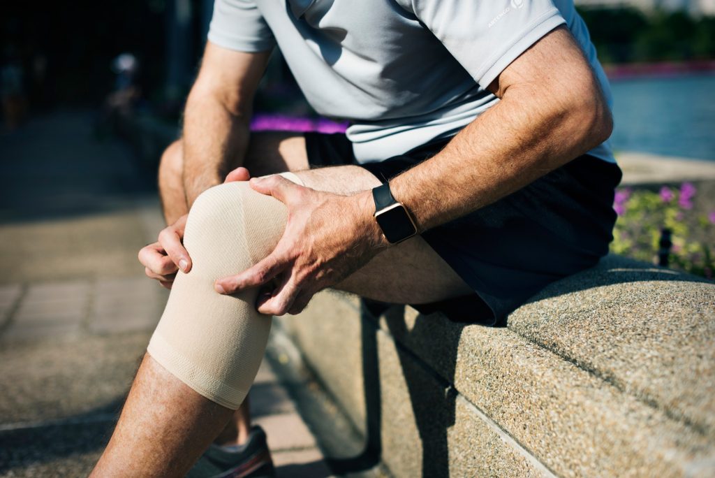 Person wearing knee support brace for OEM sports support products
