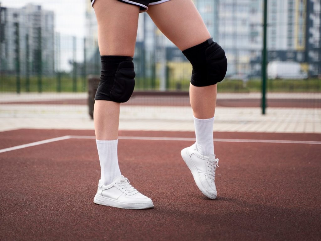 Athlete wearing sports knee pads for impact protection